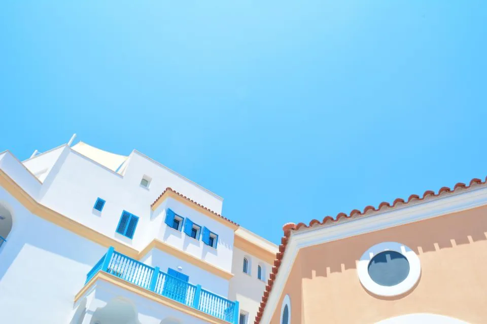 White residential buildings under a blue sky