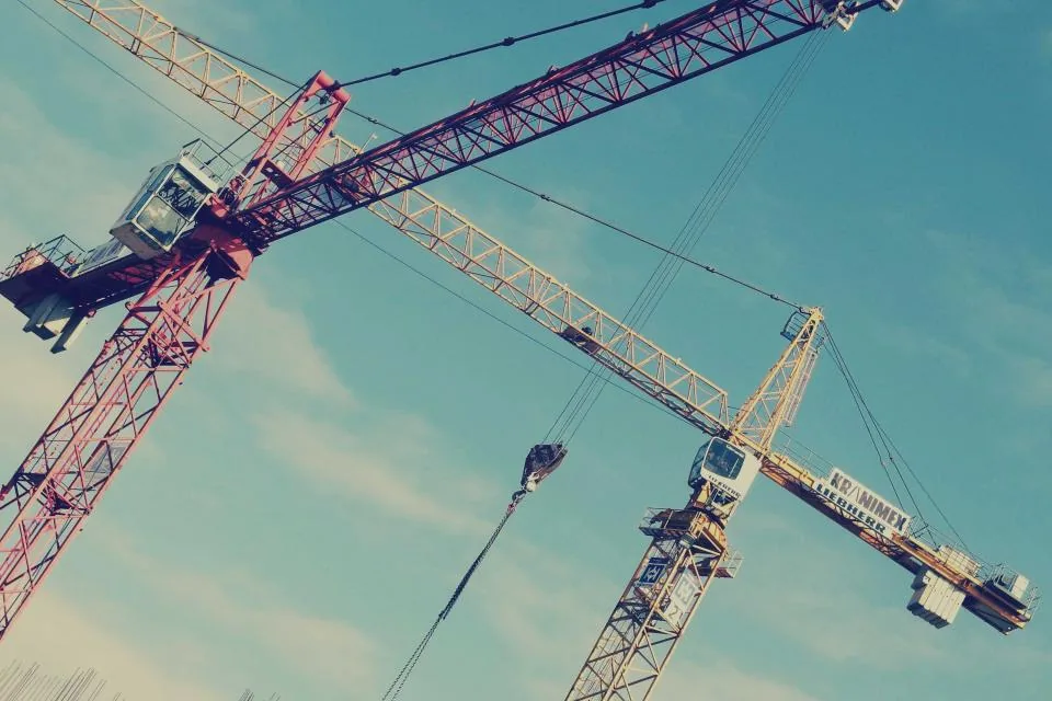 Construction cranes against the sky