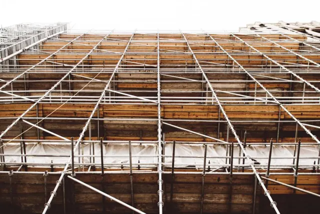 Building structure surrounded by scaffolding