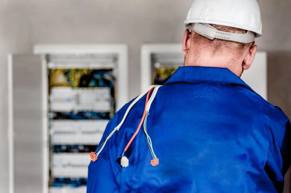 Electrician in front of an electrical distribution board