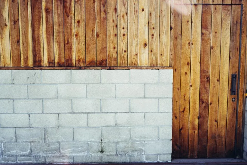 Wooden cladding above a concrete block wall